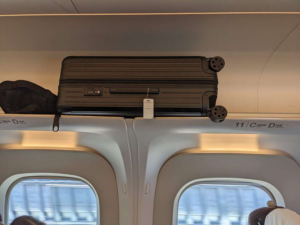 luggage stored overhead on shinkansen