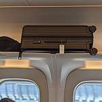 luggage stored overhead on shinkansen