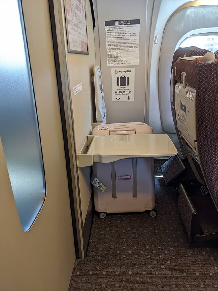 oversized luggage storage behind seats specifically reserved for oversized storage